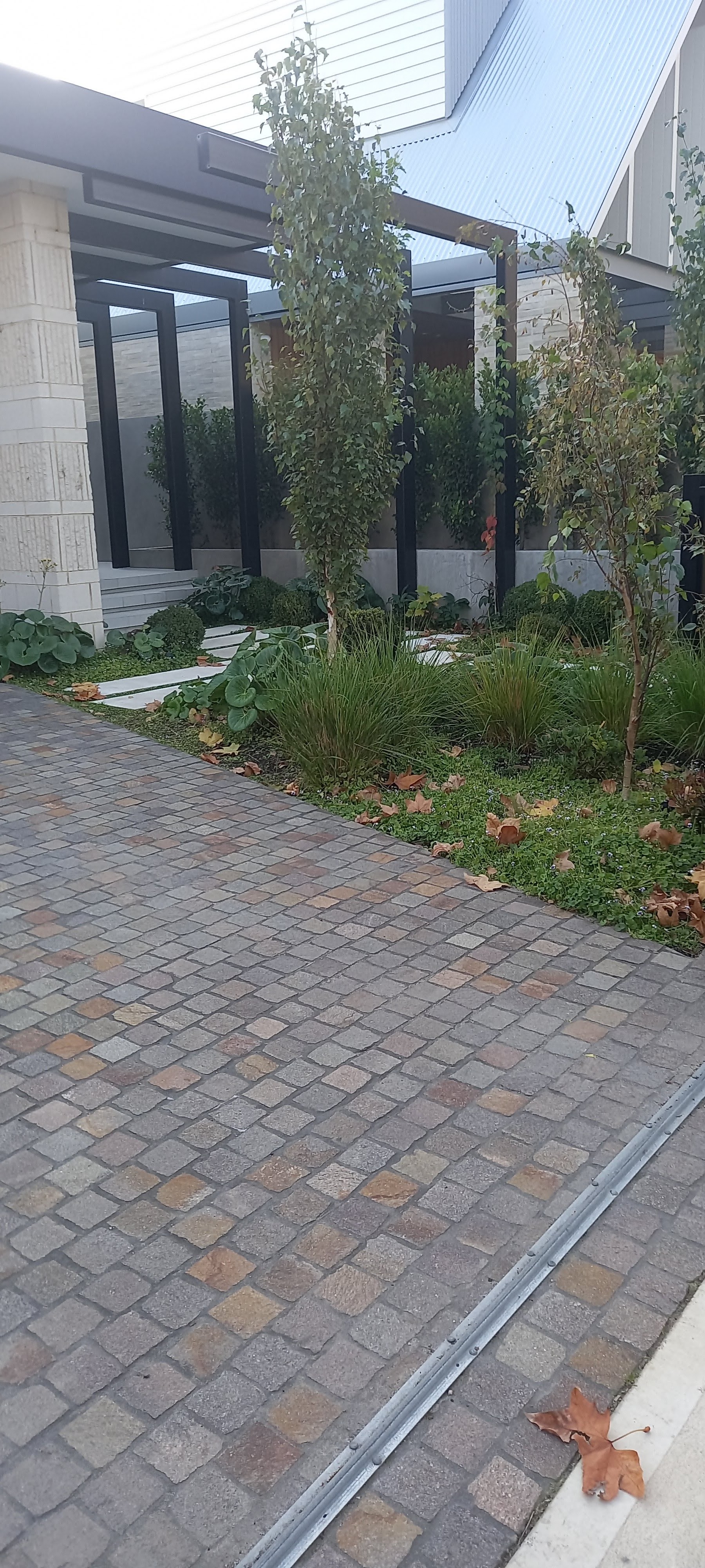 Small cobble-style pavers on a residential driveway