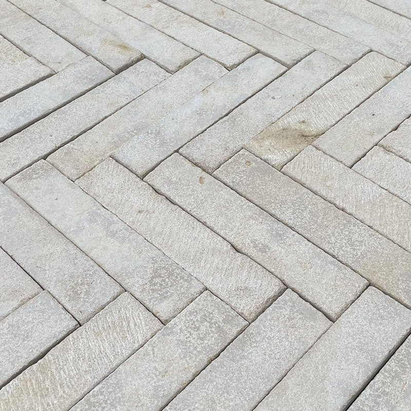 Herringbone natural stone paving in light grey tones, Melbourne outdoor area