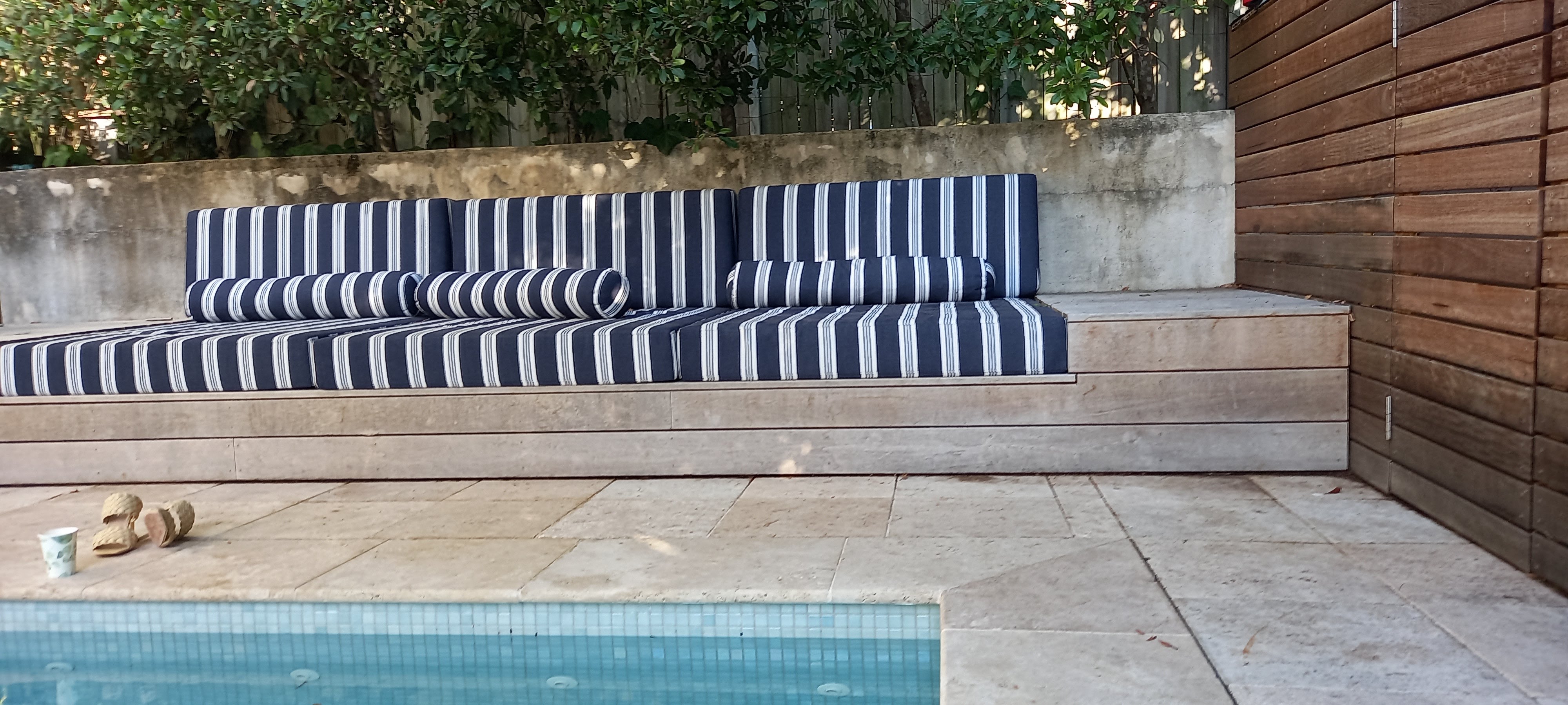 Natural stone paving around a swimming pool in a Melbourne outdoor setting